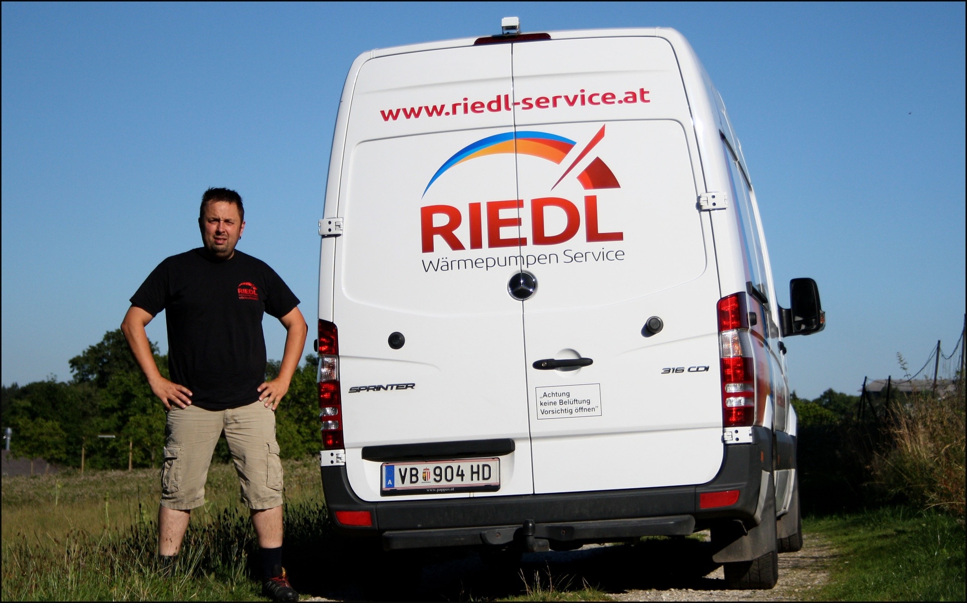 Gerhard Riedl neben dem Firmenwagen